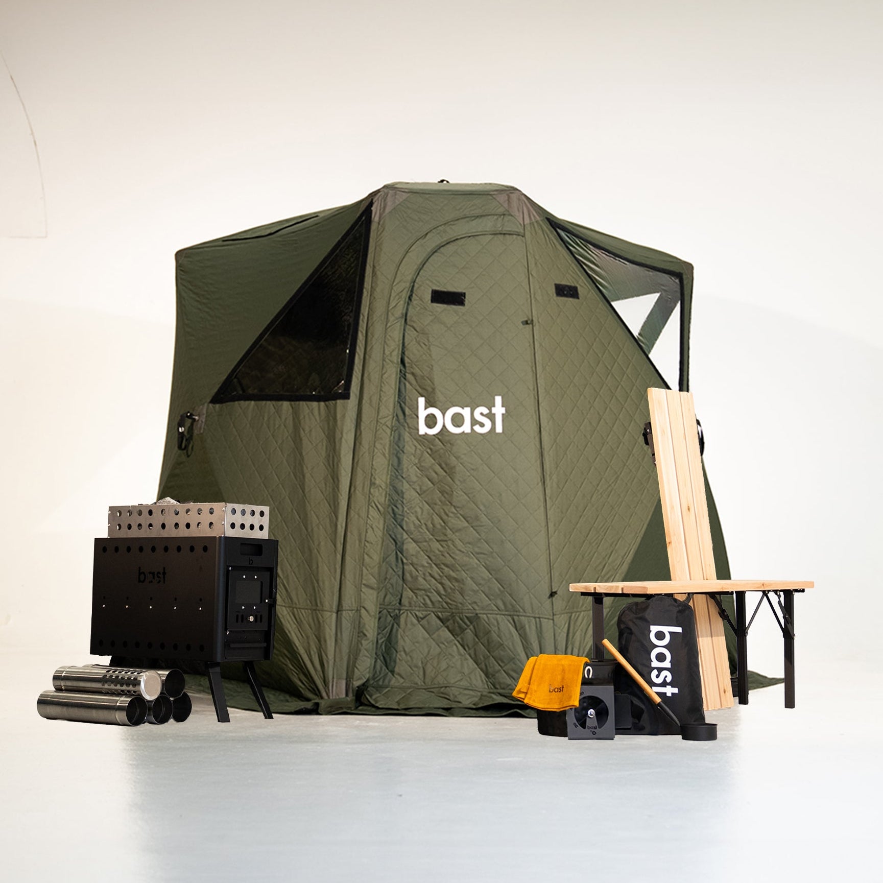 green pop-up sauna tent stove and wooden bench with 'bast' branding on a white background