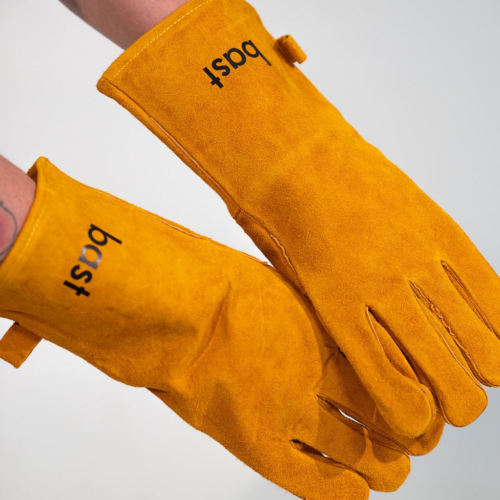 Pair of yellow barbecue gloves with 'bost' branding on a white background
