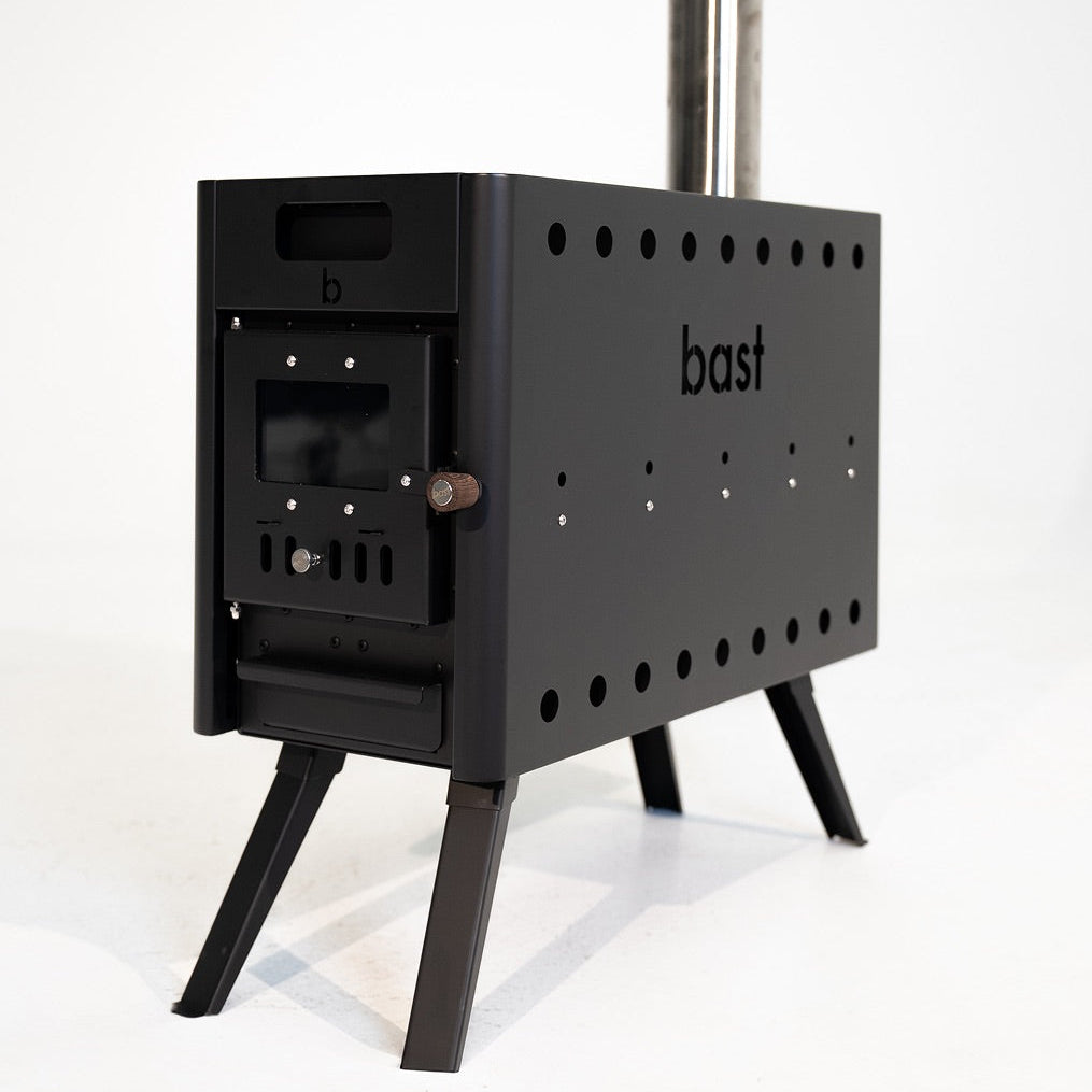 Black wood stove with 'bast' branding on a white background