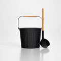 Black metal bucket with wooden handle and ladle on a white background
