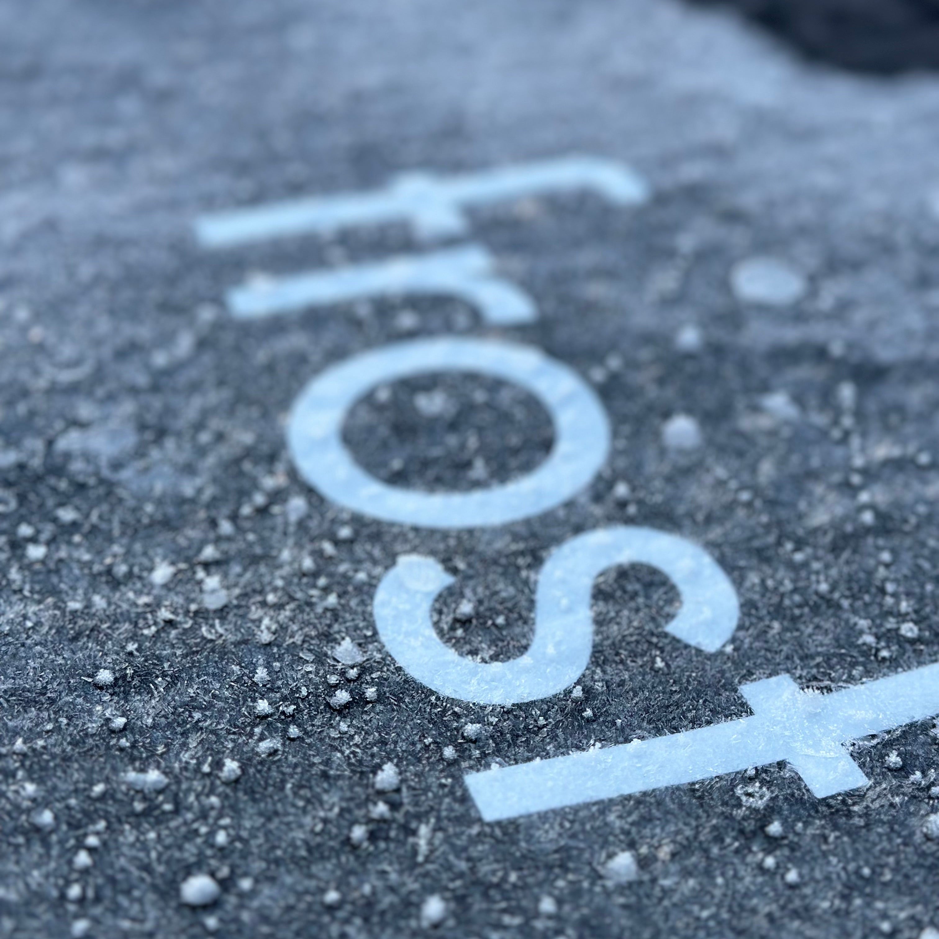 Close-up of frost on a surface with the word 'frost' written above it.
