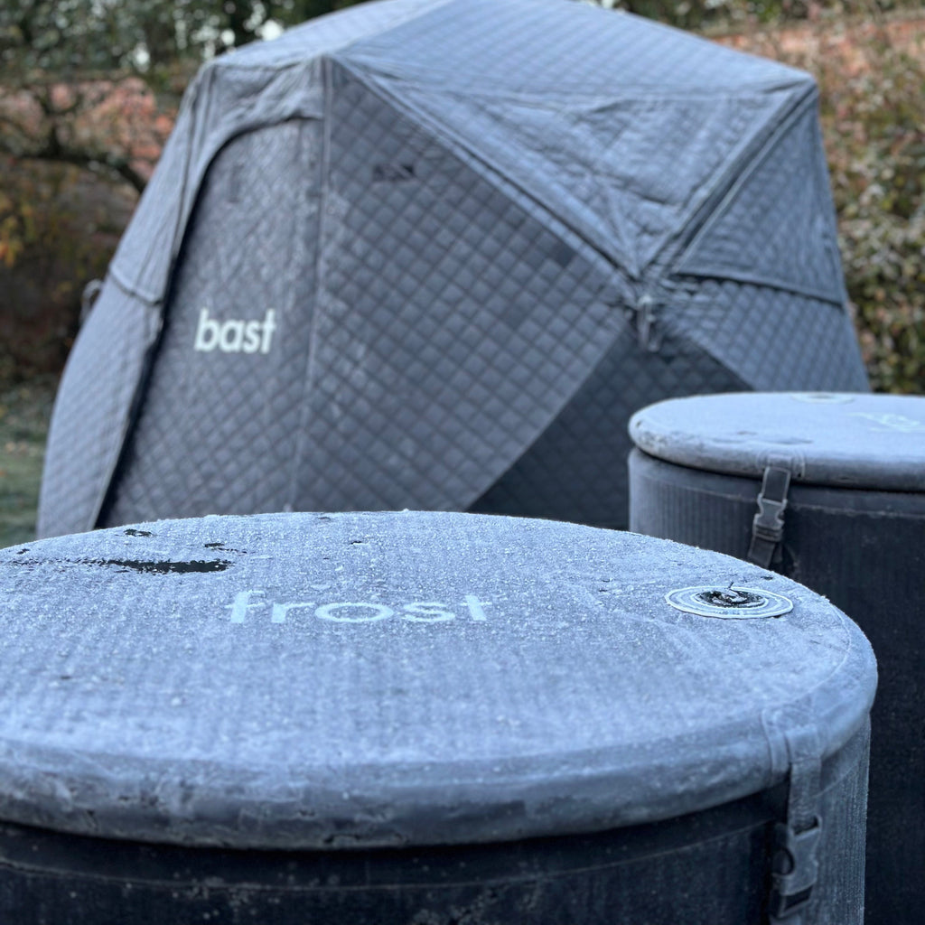 Frost covered tent with 'bast' branding on with an inflatable ice bath in foreground with 'frost' branding in a natural background